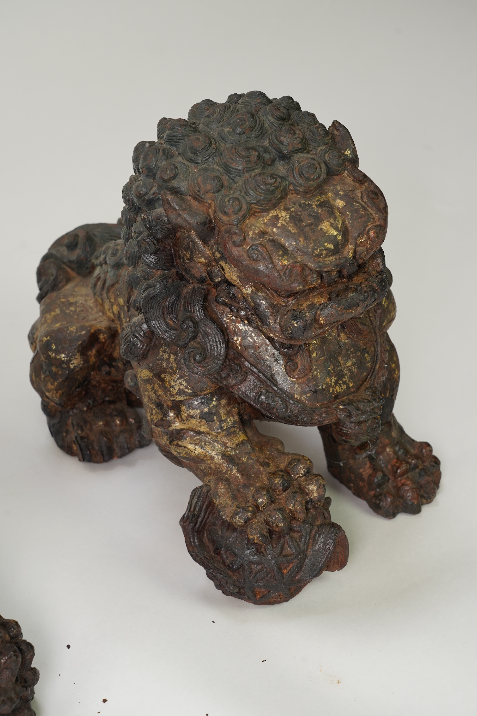 A pair of large Chinese polychrome lacquered cast iron models of lion temple guardians, Qing dynasty